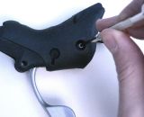 Remove the screw that holds the axle in place